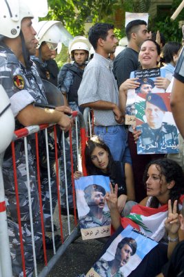 Lebanese college students holding a portrait of exiled Prime Minister Gen. Michel Aoun who led a liberation war against Syrian occupation