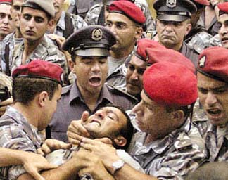 Security forces attacking a protester against shutting down MTV