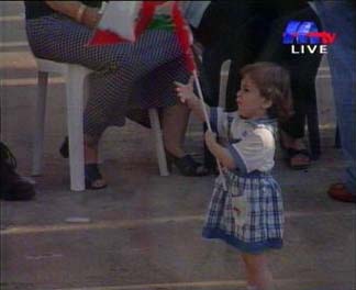A child holds a Lebanese flag during the celebration of the victory of opposition candidate over the pro-Syrian candidate